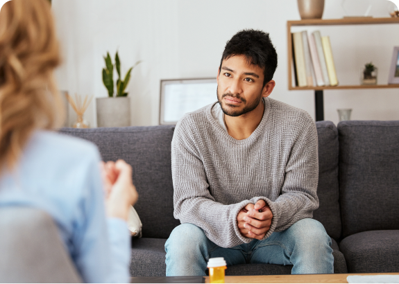 Man attentively listening during a therapy session.