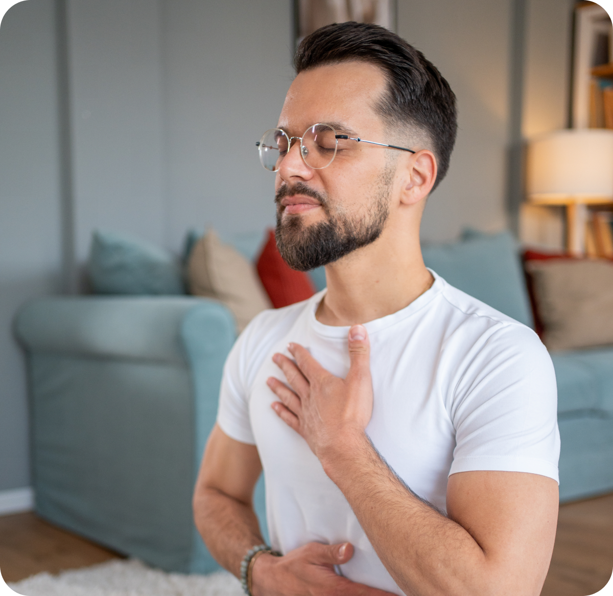Man meditating with hand on chest.